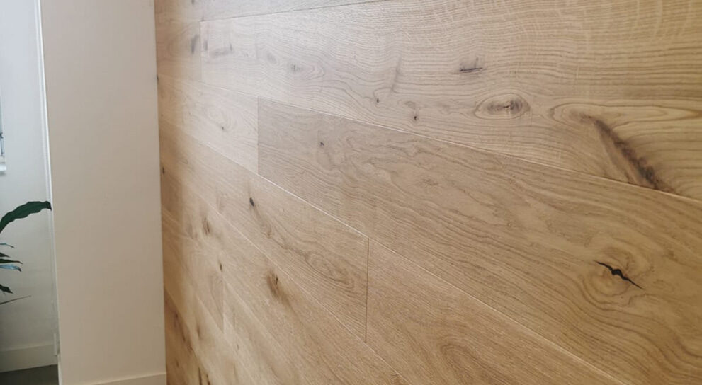Detailansicht einer Wandverkleidung aus natürlicher Eiche mit sichtbarer Holzmaserung.